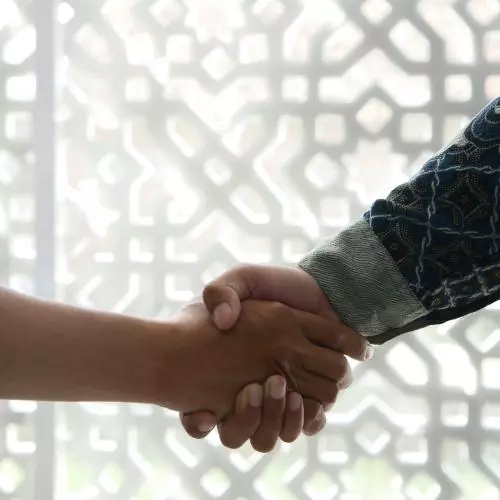 Image of two people shaking hands