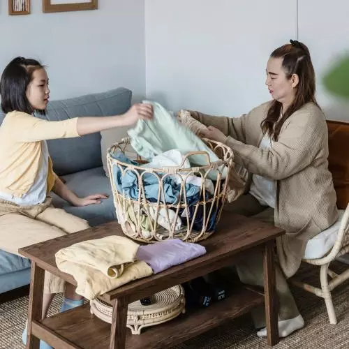 Image of woman and girl sorting laundry 