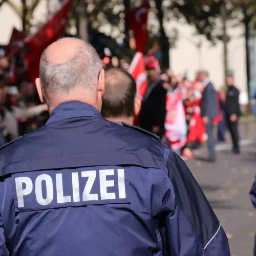 The Polizei, German police officers, walk away from the camera