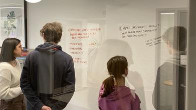 A-Level students looking at whiteboard