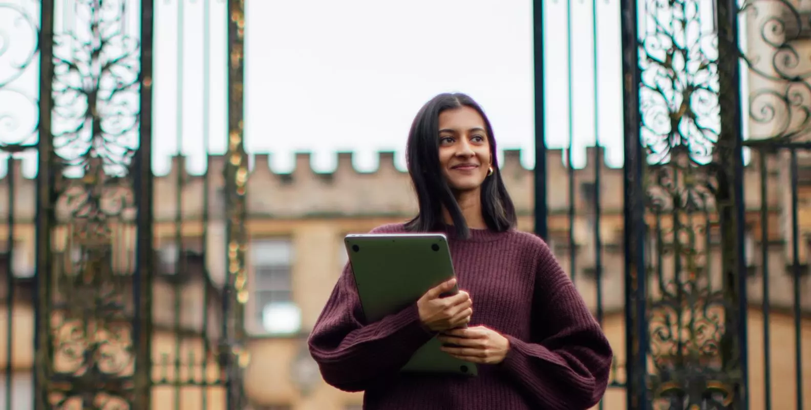 Image of student standing outside of New College