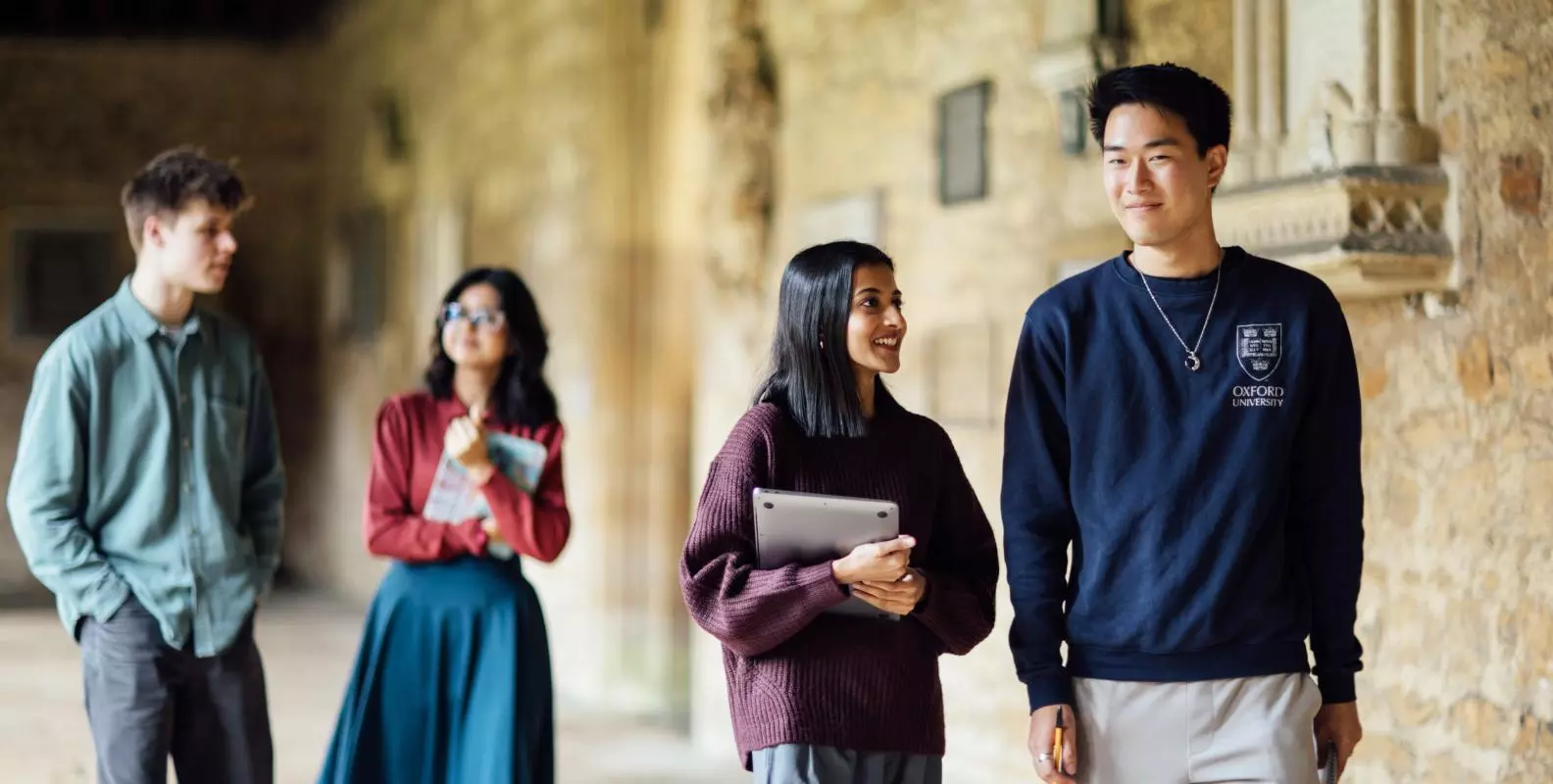 Image of four students walking in New College