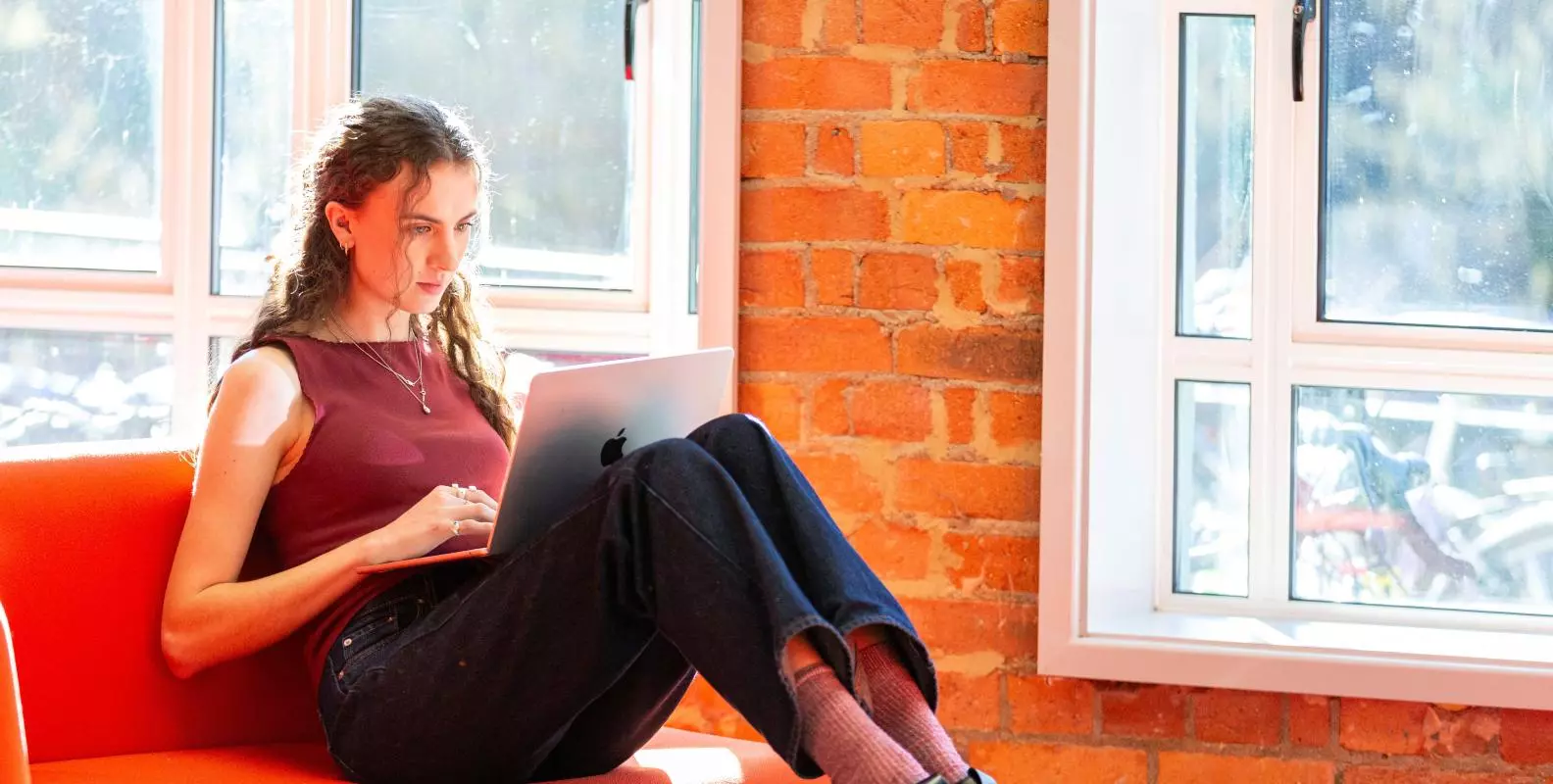 Image of a student sitting by the windows in the Department 