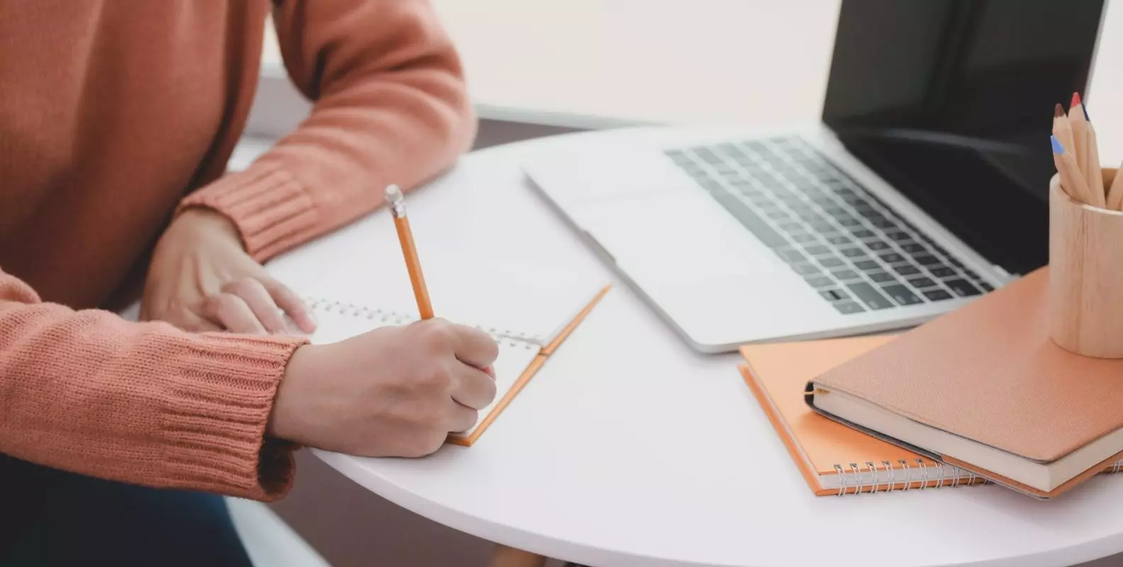 person writing at a desk