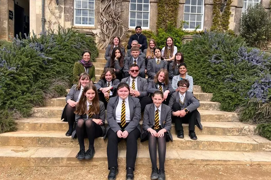 Students and teachers sit on the steps at Worcester College