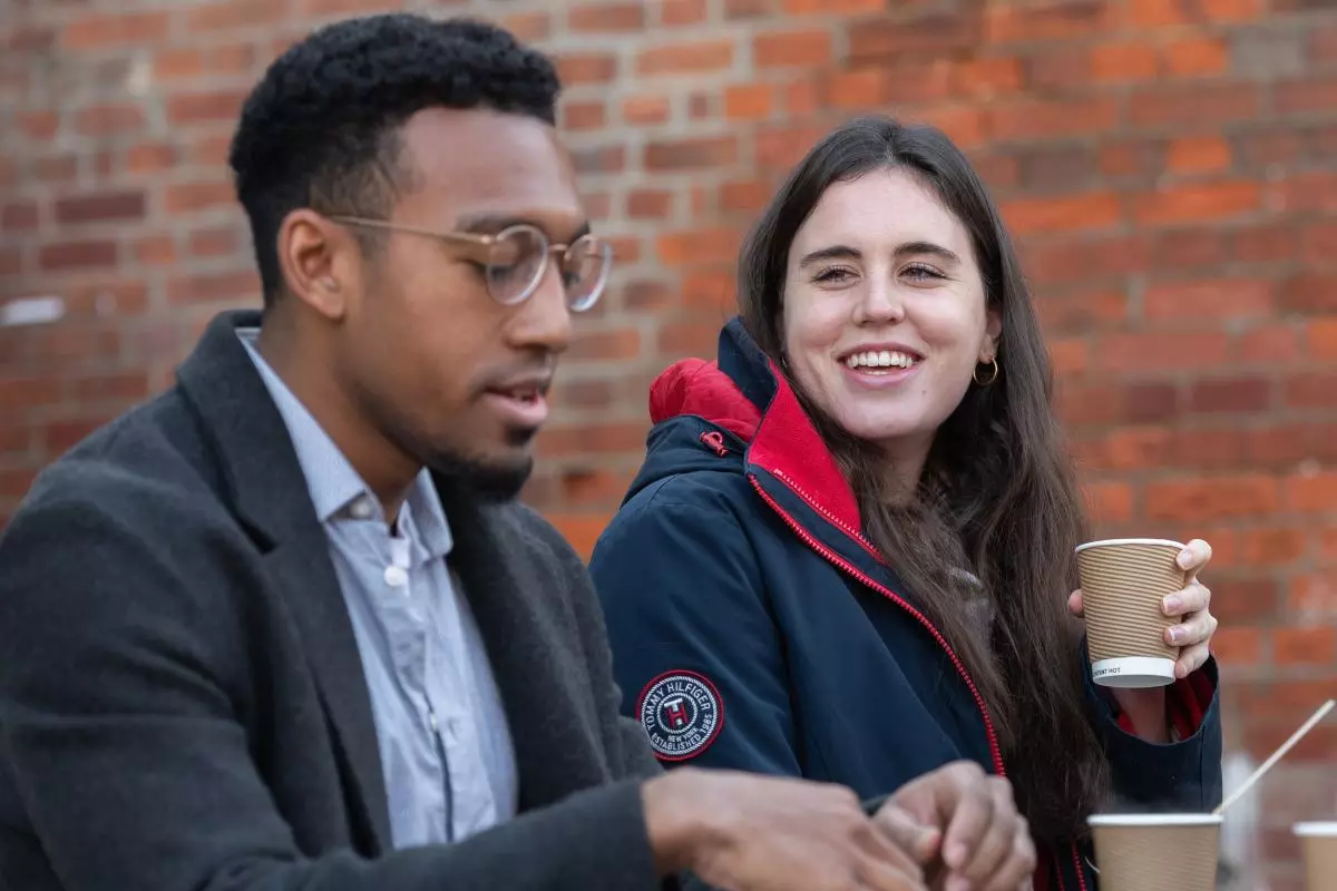 Students chat outside the Department of Sociology